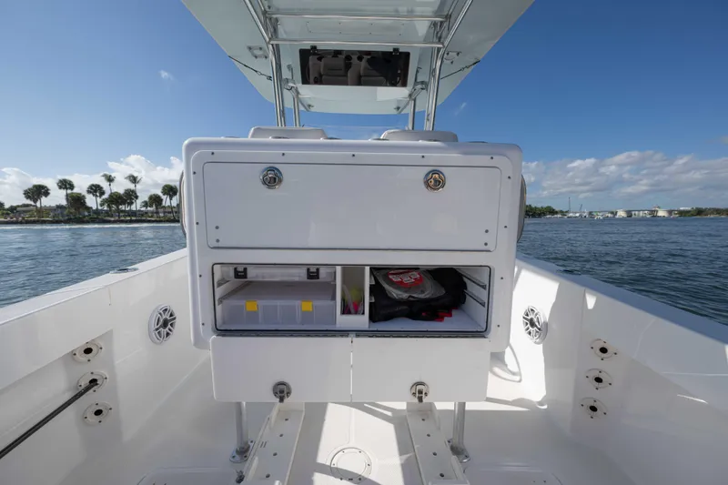 Slide: The Image of 2024 Bluewater 2550 boat interior with storage compartments, on a sunny day. - 23