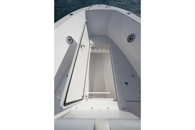 Slide: The Image of 2024 Bluewater 2550 boat interior with open storage compartment and speakers. - 31