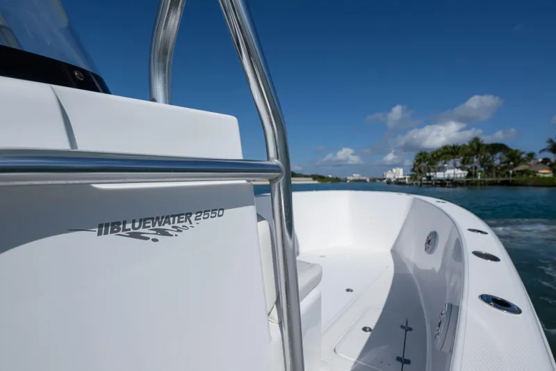 Slide: The Image of 2024 Bluewater 2550 boat on water, showcasing sleek design and branding. - 38