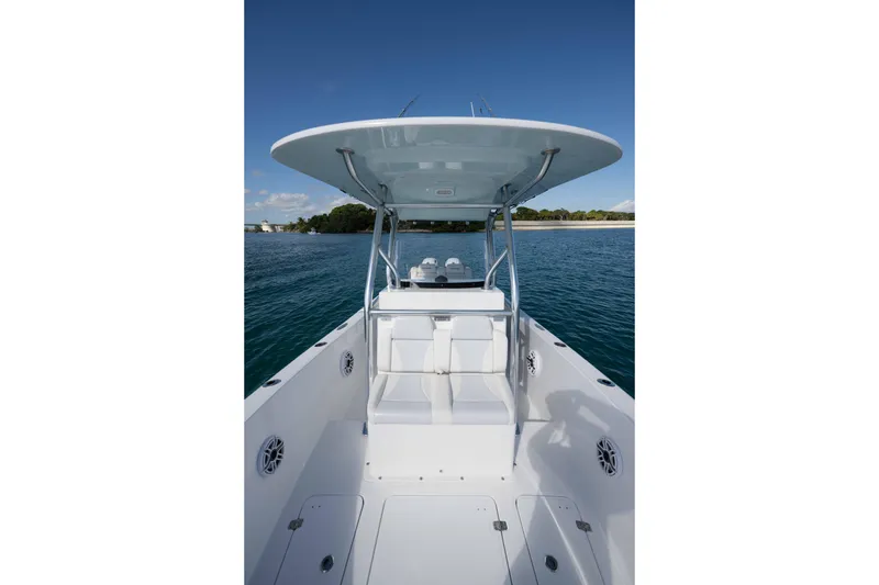 Slide: The Image of 2024 Bluewater 2550 boat on calm water, featuring sleek design and spacious deck. - 39