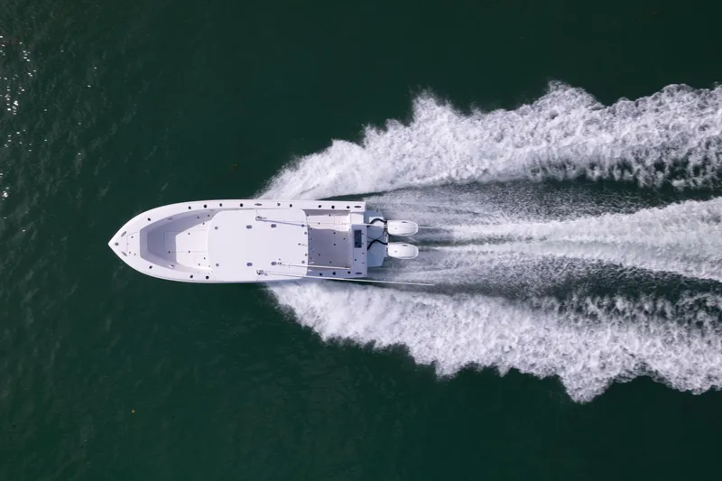 Slide: The Image of Aerial view of 2024 Bluewater 2550 boat speeding on water. - 4