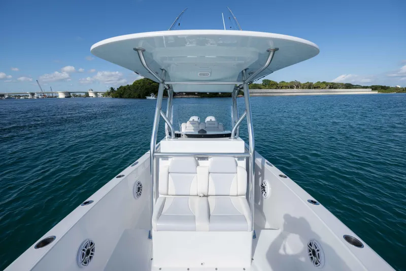 Slide: The Image of 2024 Bluewater 2550 boat on calm water, featuring spacious seating and sleek design. - 40