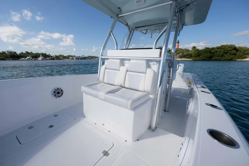 Slide: The Image of 2024 Bluewater 2550 boat interior with seating, on a sunny day by the water. - 42