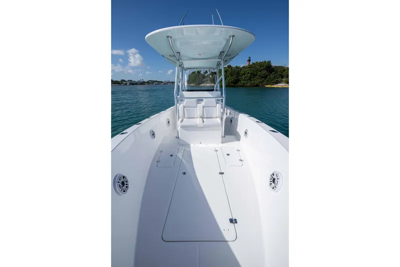 Slide: The Image of 2024 Bluewater 2550 boat on calm water, featuring spacious deck and sleek design. - 44