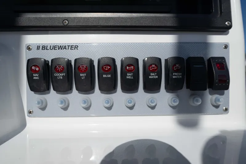 Slide: The Image of Control panel of 2024 Bluewater 2550 boat with labeled switches for various functions. - 46