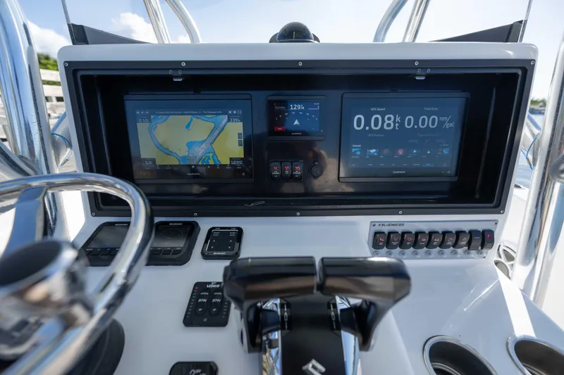 Slide: The Image of 2024 Bluewater 2550 boat dashboard with advanced navigation and control systems. - 47