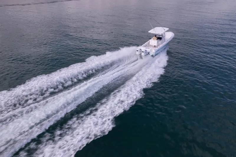 Slide: The Image of 2024 Bluewater 2550 boat cruising on open water, leaving a wake behind. - 5