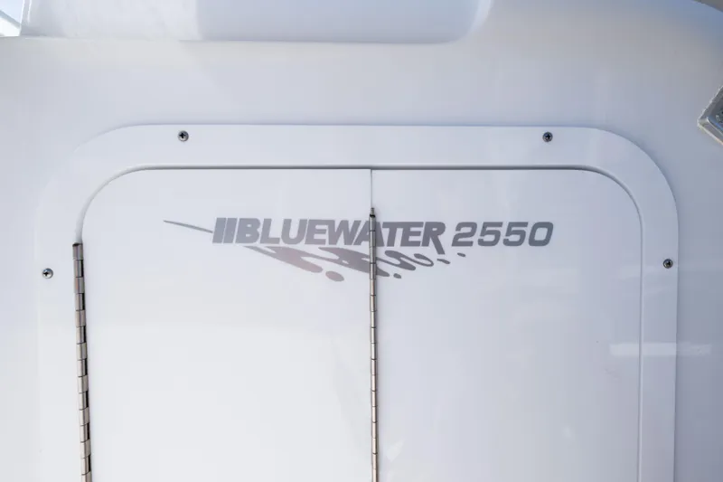Slide: The Image of 2024 Bluewater 2550 boat logo on white surface. - 50