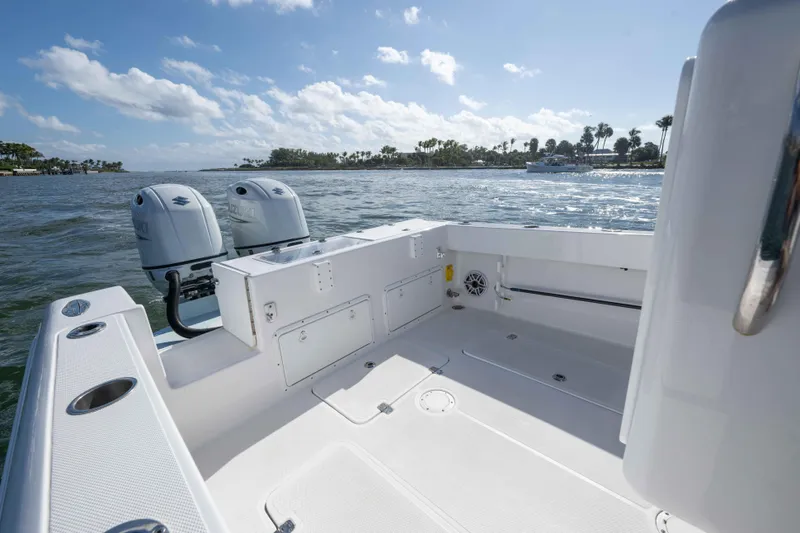 Slide: The Image of 2024 Bluewater 2550 boat with dual engines on a sunny day. - 57