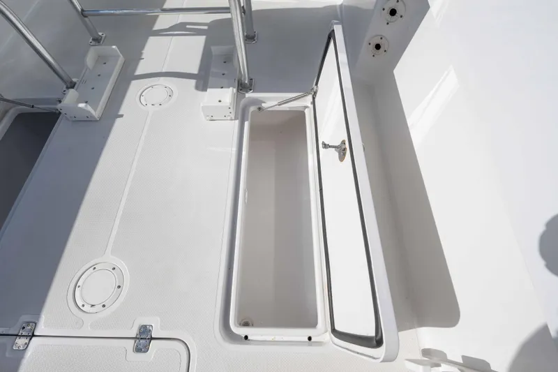 Slide: The Image of 2024 Bluewater 2550 boat deck with open storage compartment. - 58