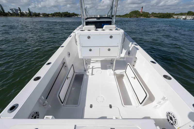 Slide: The Image of 2024 Bluewater 2550 boat interior with open storage compartments on calm water. - 60