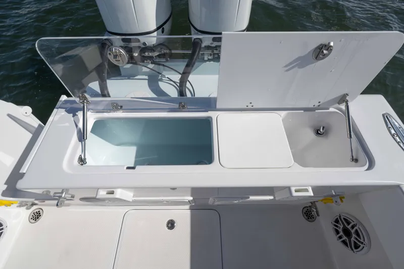 Slide: The Image of 2024 Bluewater 2550 boat with open storage compartments and sink on deck. - 62