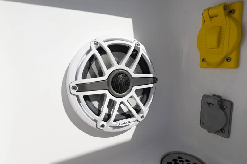 Slide: The Image of 2024 Bluewater 2550 boat featuring JL Audio speaker and electrical outlets. - 65