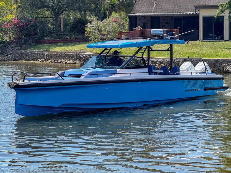 Slide: The Image of 2025 Axopar 37 Sun Top BRABUS Trim boat cruising on a sunny day. - 1