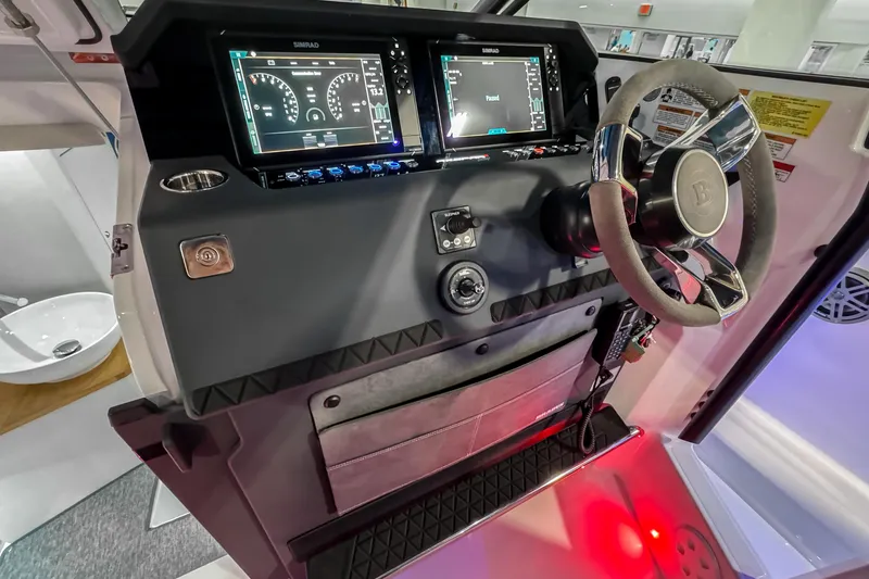 Slide: The Image of 2025 Axopar 37 Sun Top BRABUS Trim dashboard with advanced controls and steering wheel. - 22