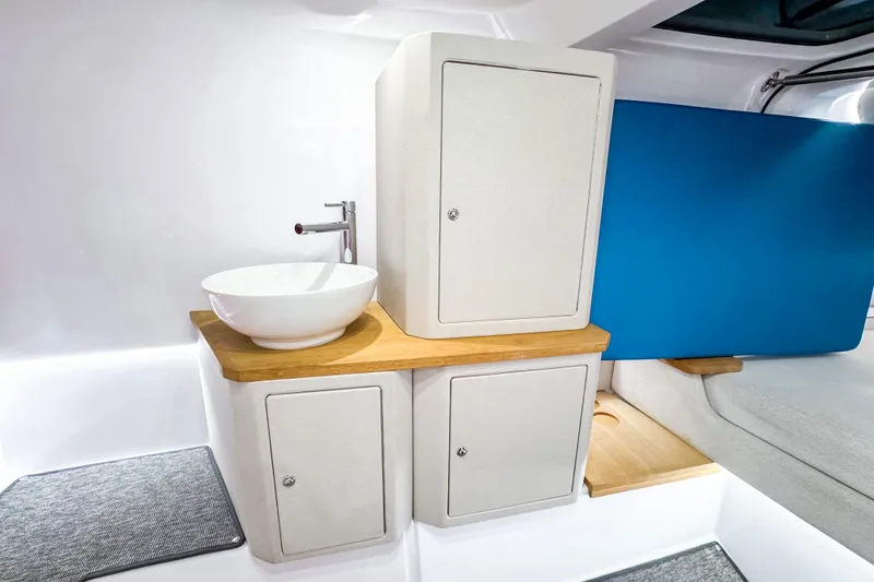 Slide: The Image of Modern interior of 2025 Axopar 37 Sun Top BRABUS Trim with sleek sink and cabinetry. - 33