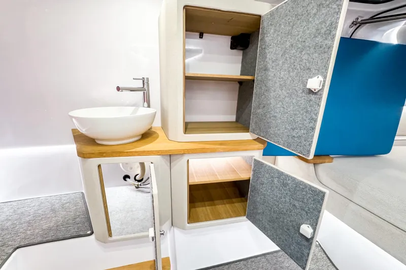 Slide: The Image of Modern interior of 2025 Axopar 37 Sun Top BRABUS Trim with stylish sink and storage. - 34