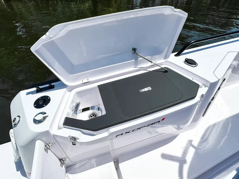 Slide: The Image of 2025 Axopar 37 Sun Top BRABUS Trim boat with open storage compartment. - 14