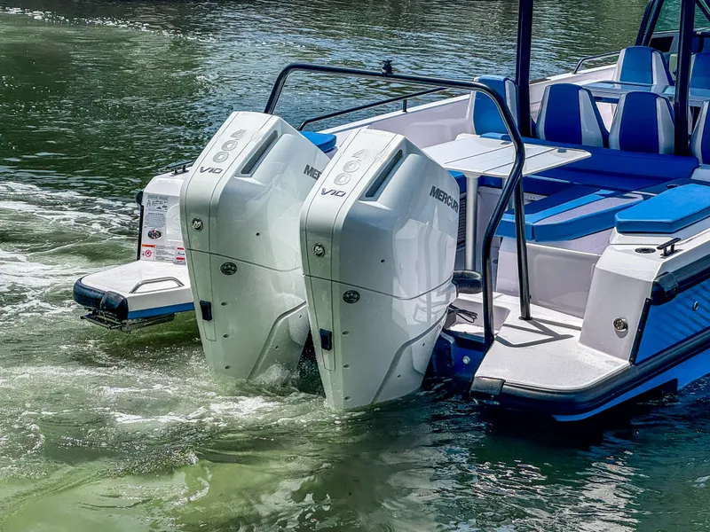 Slide: The Image of 2025 Axopar 37 Sun Top BRABUS Trim with dual Mercury V10 engines on water. - 6