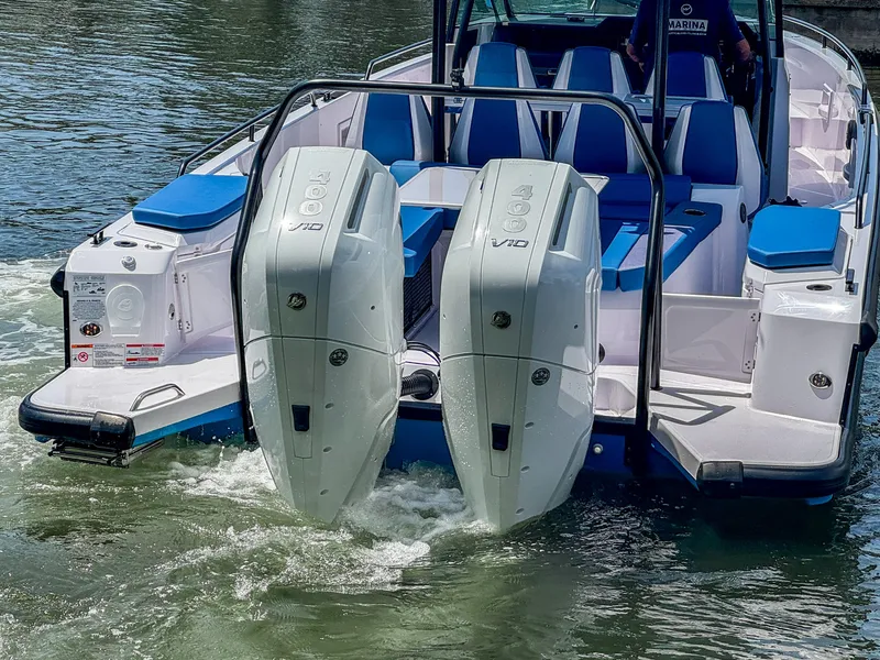 Slide: The Image of 2025 Axopar 37 Sun Top BRABUS Trim with dual outboard engines on water. - 7