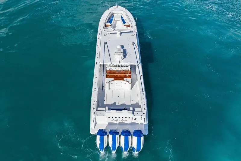 Slide: The Image of Aerial view of 2025 HCB 53 Suenos RXV boat on clear blue water. - 10