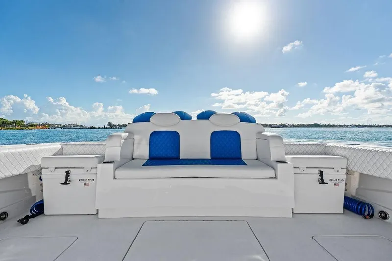 Slide: The Image of 2025 HCB 53 Suenos RXV boat interior with blue and white seating, ocean view. - 14