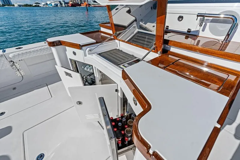 Slide: The Image of 2025 HCB 53 Suenos RXV boat with luxurious deck and beverage storage. - 19