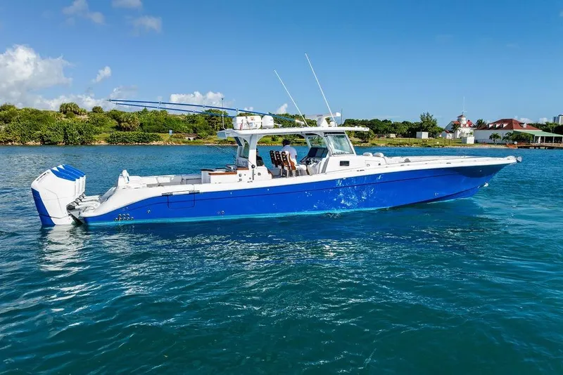 Slide: The Image of 2025 HCB 53 Suenos RXV boat on clear blue water, side view. - 2