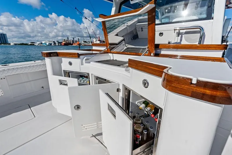 Slide: The Image of 2025 HCB 53 Suenos RXV yacht interior with open cabinets and beverage storage. - 20