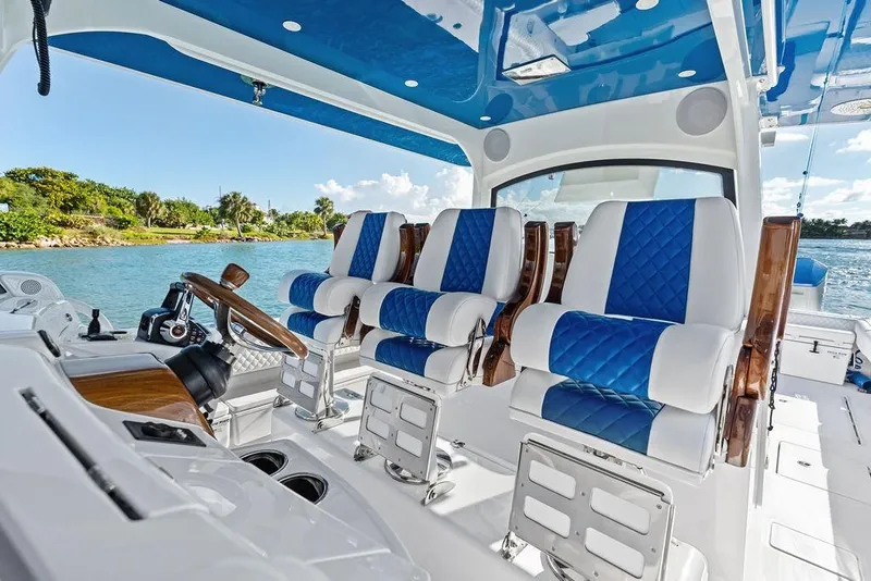 Slide: The Image of Luxury interior of 2025 HCB 53 Suenos RXV boat with blue and white seating. - 21