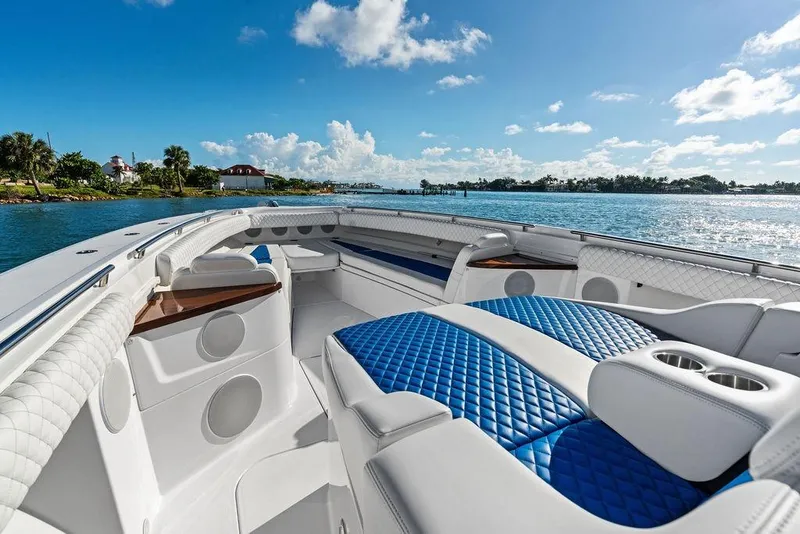 Slide: The Image of Luxurious 2025 HCB 53 Suenos RXV boat interior with blue quilted seating on a sunny day. - 30