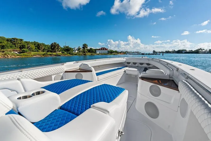 Slide: The Image of Luxurious 2025 HCB 53 Suenos RXV boat interior with blue and white seating on a sunny day. - 31
