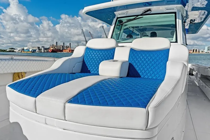 Slide: The Image of Luxurious seating on 2025 HCB 53 Suenos RXV boat with blue and white upholstery. - 32