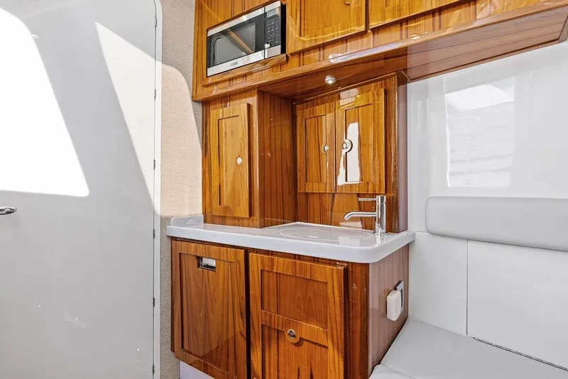 Slide: The Image of Luxurious wooden cabinetry and sink in 2025 HCB 53 Suenos RXV boat interior. - 35