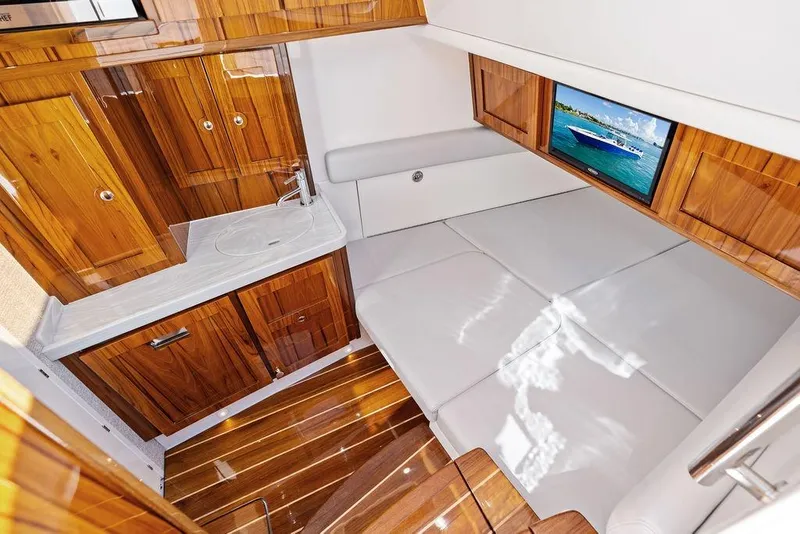 Slide: The Image of Luxurious interior of 2025 HCB 53 Suenos RXV with wood cabinetry and cozy seating. - 36