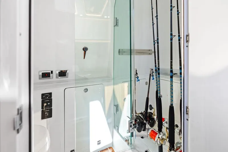 Slide: The Image of Interior of 2025 HCB 53 Suenos RXV boat with fishing rods and controls. - 41