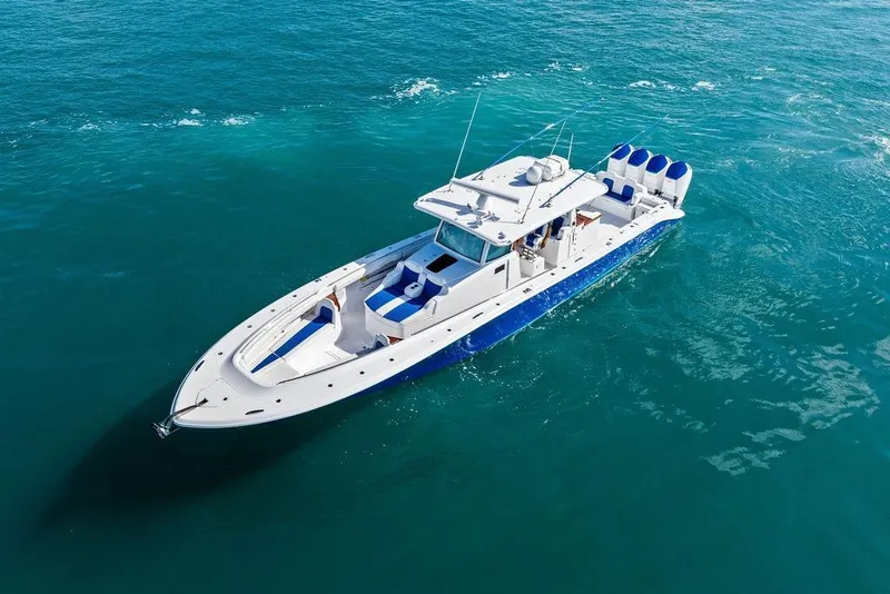 Slide: The Image of 2025 HCB 53 Suenos RXV luxury boat cruising on clear blue water. - 6