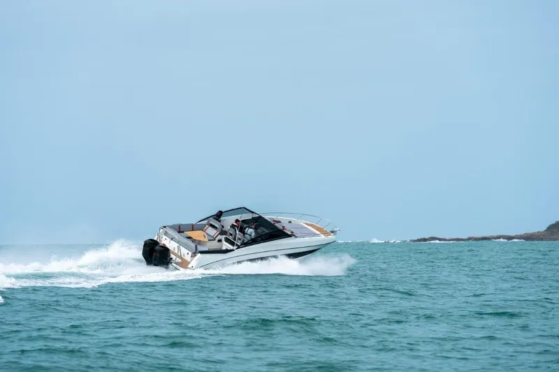 Slide: The Image of 2024 Beneteau Flyer 10 cruising on open water. - 14