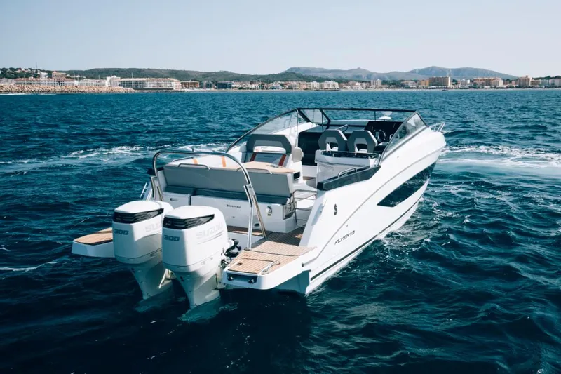 Slide: The Image of 2024 Beneteau Flyer 10 motorboat cruising on open water. - 17