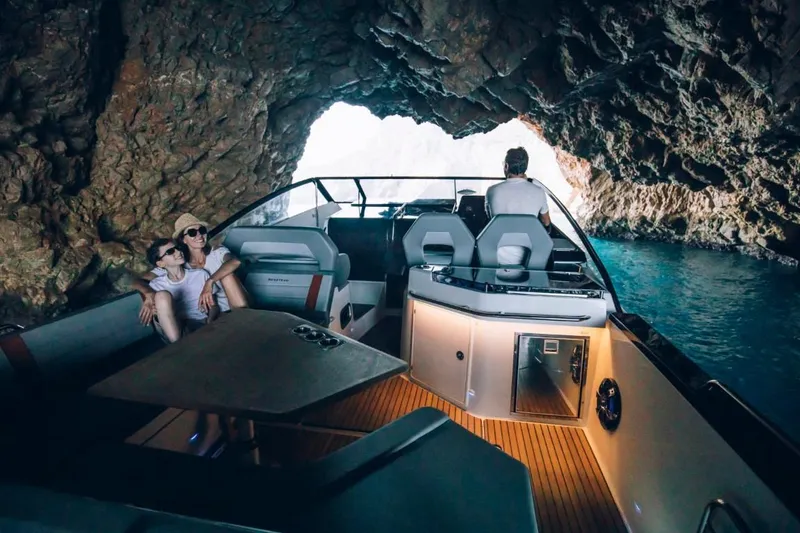Slide: The Image of 2024 Beneteau Flyer 10 cruising through a scenic cave with passengers onboard. - 36