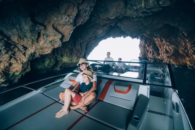 Slide: The Image of Family enjoying a boat ride on a 2024 Beneteau Flyer 10 inside a scenic cave. - 37