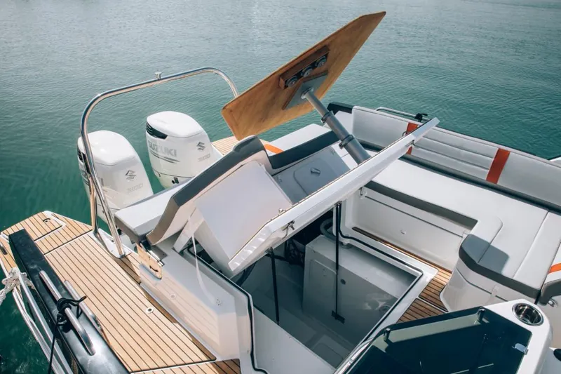 Slide: The Image of 2024 Beneteau Flyer 10 boat with open storage compartment and twin engines. - 45