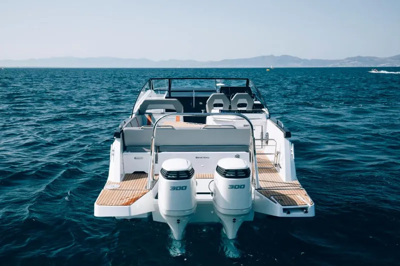 Slide: The Image of 2024 Beneteau Flyer 10 boat with twin 300 HP engines on open water. - 10