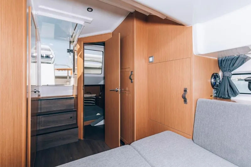Slide: The Image of 2024 Beneteau Flyer 10 interior cabin with modern wood finish and cozy seating. - 40