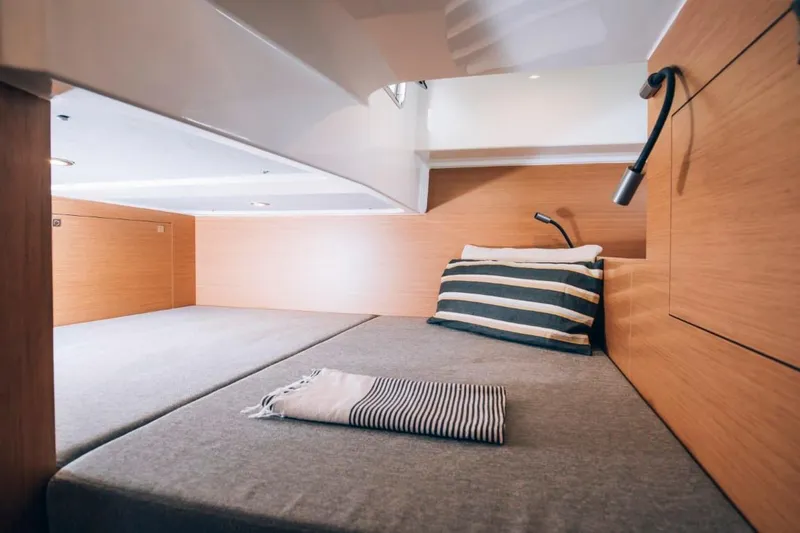Slide: The Image of 2024 Beneteau Flyer 10 cabin interior with modern bedding and lighting. - 41