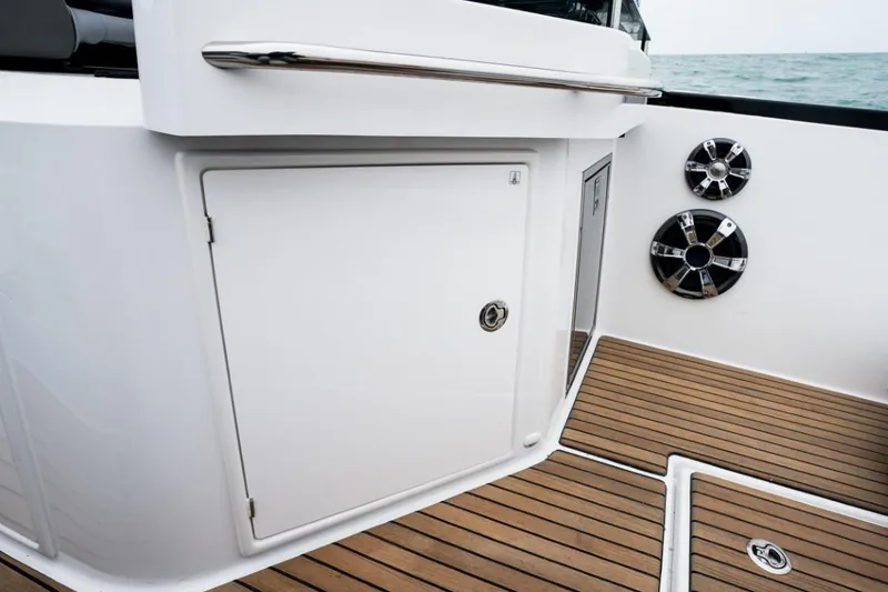 Slide: The Image of 2024 Beneteau Flyer 10 deck with storage compartment and teak flooring. - 49