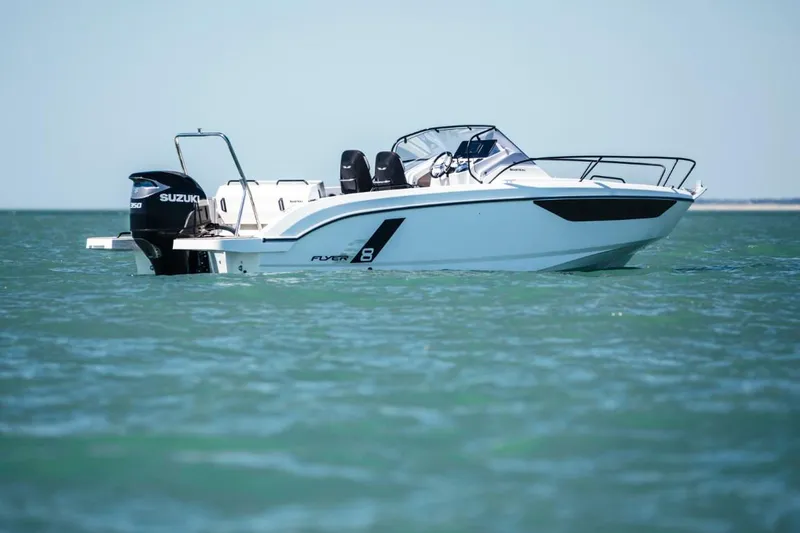 Slide: The Image of 2025 Beneteau Flyer 8 SUNdeck boat on calm water, side view. - 7