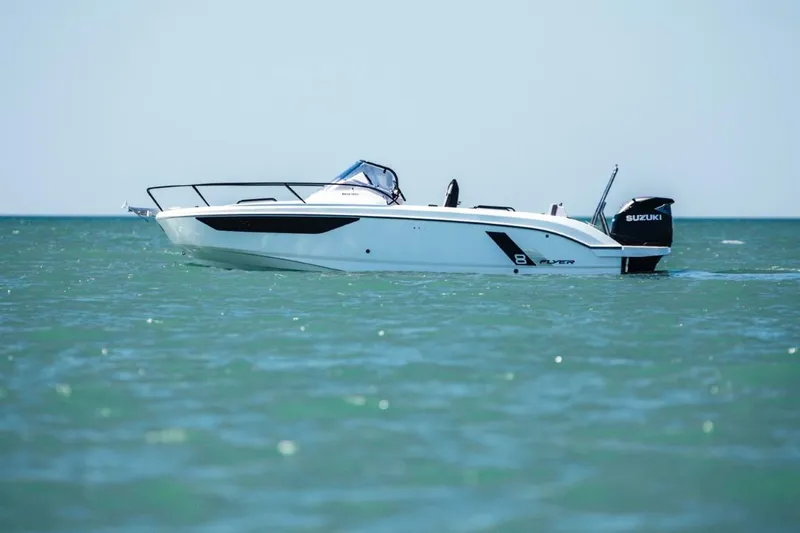 Slide: The Image of 2025 Beneteau Flyer 8 SUNdeck boat on open water, side view. - 8