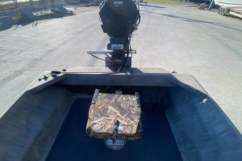 Slide: The Image of 2018 Gator Tail 17' boat with camo seat and motor, parked outdoors. - 14