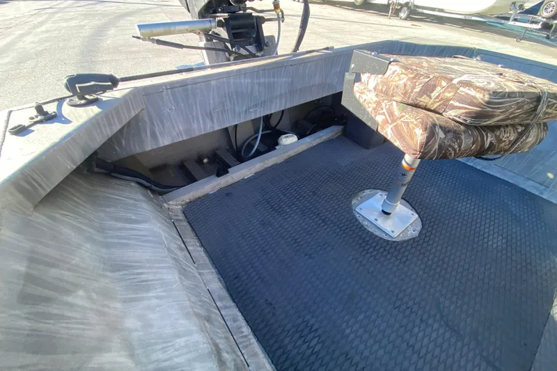 Slide: The Image of 2018 Gator Tail 17' boat interior with camo seat and motor controls. - 18